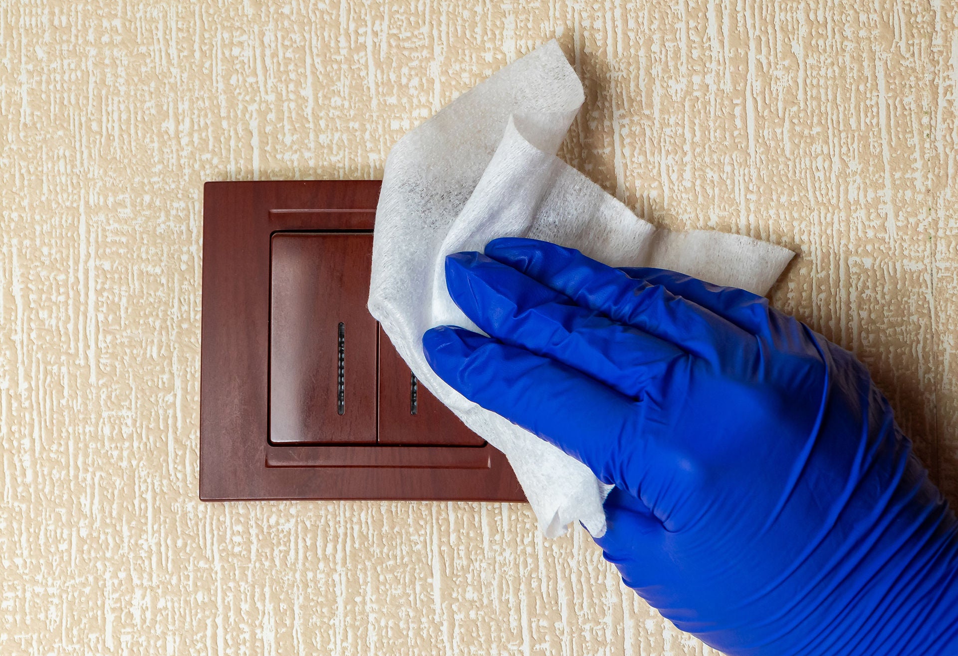 Disinfection and cleaning of light switches and home surfaces. The concept of preventive protection against coronavirus.