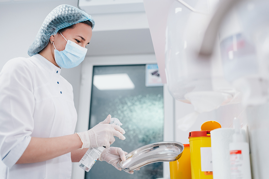 Healthcare worker using NUGEN® HLD-CD disinfectant in medical environment